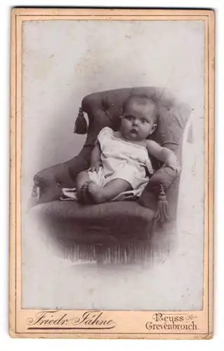 Fotografie Friedr. Jähne, Neuss, Crefelder Strasse, Staunendes Baby auf einem Sessel