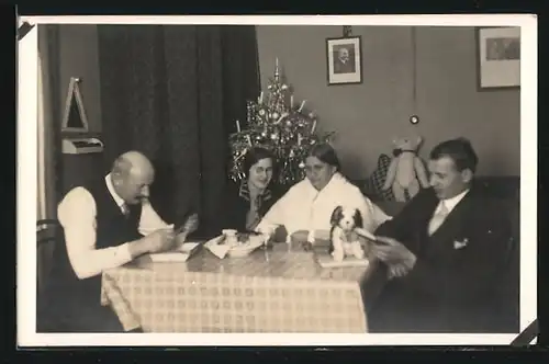 Foto-AK Familie bei der weihnachtlichen Bescherung, Teddy und Plüschhund