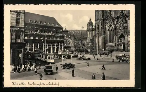 AK Köln /Rh., Strassenbahnen auf dem Domplatz vor dem Bahnhof