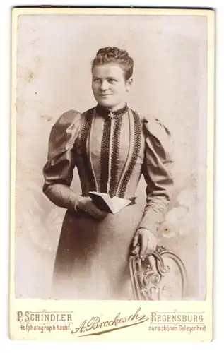 Fotografie P. Schindler Nachf. A. Brockesch, Regensburg, Junge Dame im Kleid mit Buch