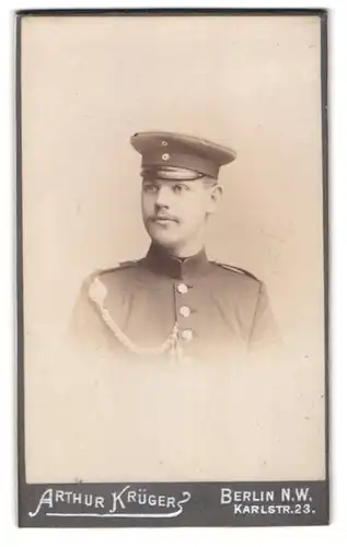 Fotografie Arthur Krüger, Berlin, Karlstrasse 23, Soldat in Uniform mit Schirmmütze und Schützenschnur