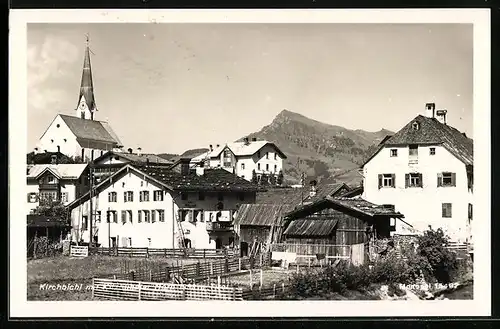 AK Kirchbichl, Ortsansicht mit Kirche und Berggipfel