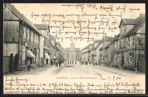 AK Arolsen, Untere Bahnhofstrasse mit Geschäften und Kirche