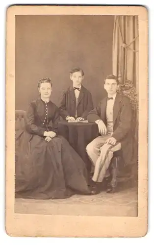 Fotografie unbekannter Fotograf und Ort, Mutter mit ihren beiden Söhnen im Atelier