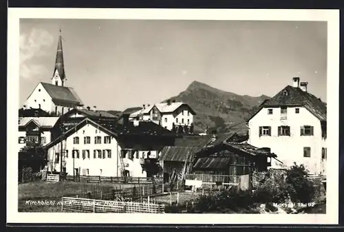 AK Kirchbichl, Ortsansicht mit Kirche und Berggipfel