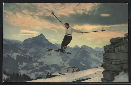 AK Mann auf Skiern bei einem Sprung, Im Hintergrund Berge