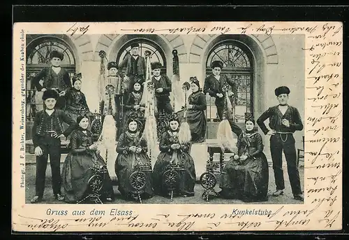AK Männer und Frauen in elsass-lothringischer Tracht in einer Kunkelstube