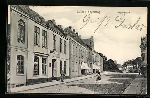 AK Bad Segeberg, Die Kirchstrasse mit Apotheke, Mädchen mit Fahrrad