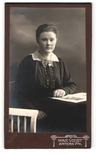 Fotografie Max Voigt, Artern i / Th., Portrait hübsch gekleidete Dame mit Zeitung am Tisch sitzend