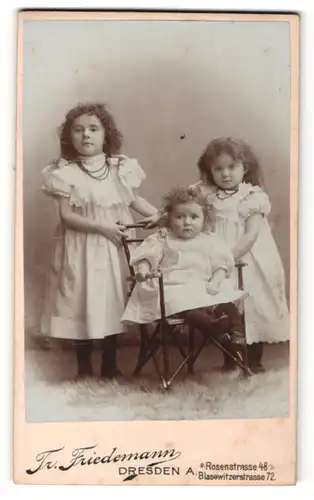 Fotografie Tr. Friedemann, Dresden-A, Portrait zwei kleine Mädchen in hübschen Kleidern mit Kleinkind