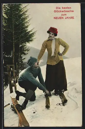 AK Herr hilft einer Dame beim Ski fahren