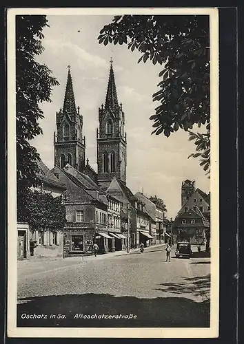 AK Oschatz /Sa., Altoschatzerstrasse mit Kirche und Geschäften