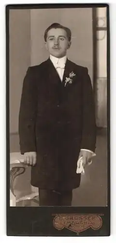 Fotografie C. Grosser, Limbach i. Sa., Portrait elegant gekleideter Herr mit Handschuhen an Tisch gelehnt