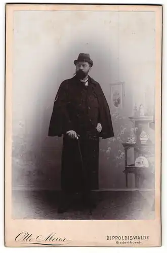 Fotografie Otto Meier, Dippoldiswalde, Portrait stattlicher Herr im Mantel mit Hut und Stock