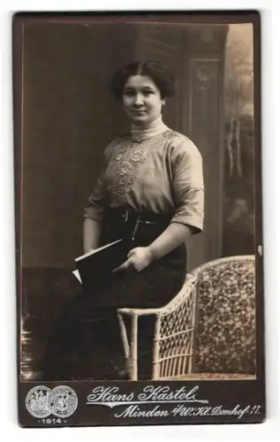 Fotografie Hans Kastel, Minden i /W., Portrait junge Dame in hübscher Bluse mit Buch auf Lehne sitzend