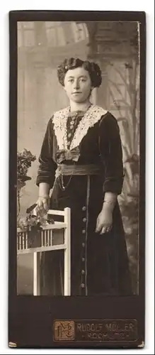 Fotografie Rudolf Müller, Rochlitz, Junge Dame in dunklem Kleid mit Schleife und langer Kette leicht am Lächeln