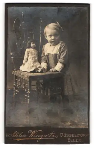 Fotografie Atelier Weingartz, Düsseldorf, kleines Mädchen mit ihrer Puppe auf dem Stuhl