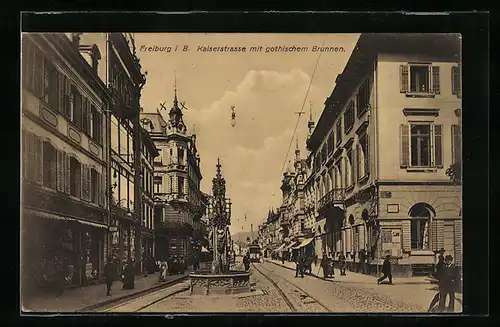 AK Freiburg i. B., Kaiserstrasse mit gothischem Brunnen und Strassenbahn