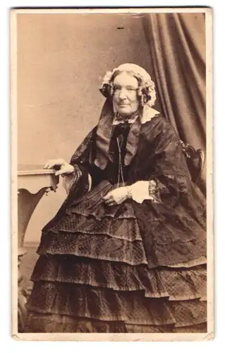 Fotografie R. Cade, Ipswich, ältere Dame im gerafften Kleid mit Haube und Locken