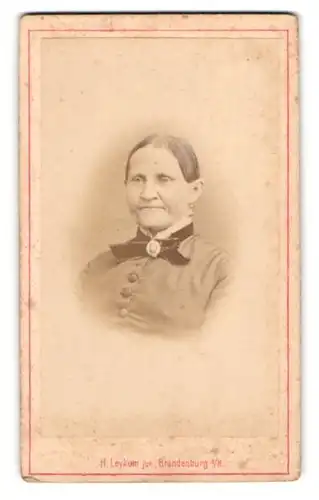 Fotografie H. Leykum, Brandenburg a. H., ältere Dame mit Fliege und Brosche