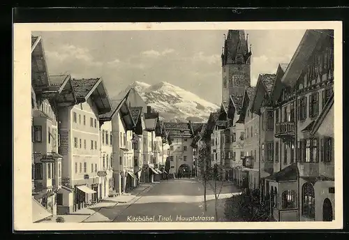 AK Kitzbühel, Hauptstrasse mit Kirche im Sonnenschein
