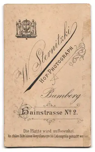 Fotografie W. Sternitzki, Bamberg, Hainstr. 2, Junge blonde Dame in schwarzem Kleid mit silberner Brosche