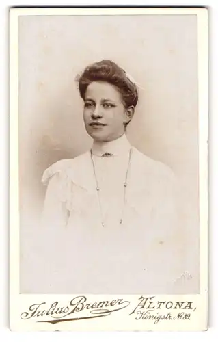 Fotografie Julius Bremer, Altona, Junge Frau in Trachtenkleid mit Hochsteckfrisur und Hals- und Kopfschmuck