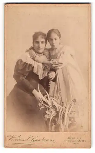 Fotografie Richard Kasbaum, Berlin, Friedrich-Str. 125, Junge Mutter in schwarzem Kleid mit Tochter in weiss