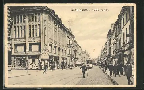 AK Mönchengladbach, Crefelderstrasse mit Geschäften und Strassenbahn im Sonnenschein