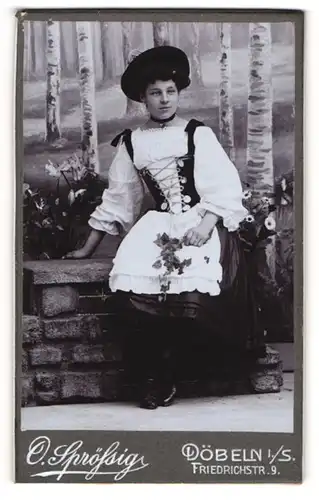 Fotografie O. Sprössig, Döbeln i. Sa., junge Dame im Trachtenkleid mit Blumen in der Hand