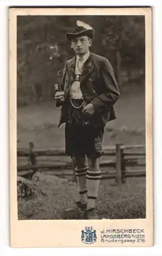 Fotografie J. Hirschbeck, Landsberg / Lech, junger bayrischer Mann in Tracht mit Lederhose und Pfeife