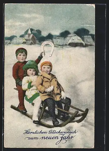 AK Kinder fahren mit ihrem Schlitten ins neue Jahr