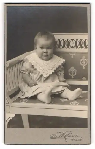 Fotografie A. Wiklund, Falun, Baby sitzend in Kleid mit weissem Spitzenkragen