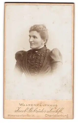 Fotografie Jacob Gebrüder, Berlin, Portrait hübsche Dame mit Dutt in prachtvoll gerüschtem Kleid