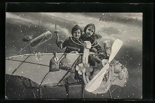 AK Zwei kleine Schornsteinfeger im Flugzeug im Schnee, Neujahrsgruss