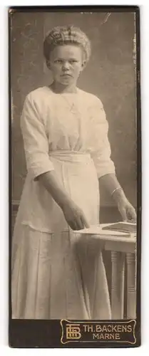 Fotografie Th. Backens, Marne, Portrait bürgerliche Dame mit Zeitung an Tisch gelehnt