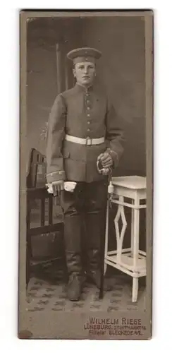 Fotografie Wilhelm Riege, Lüneburg, Stintmarkt 16, junger Soldat in Uniforn mit Säbel und Krätzchen