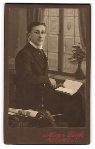 Fotografie Alwin Teich, Neustadt i. S., Portrait junger Mann im Anzug mit Krawatte und Buch