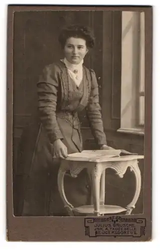 Fotografie Julius Grusche, Neugersdorf i / S., Portrait bürgerliche Dame mit Heft am Tisch lehnend