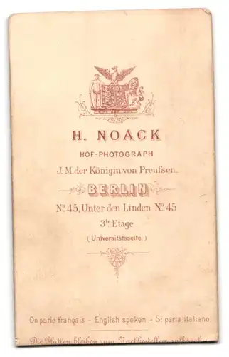 Fotografie H. Noack, Berlin, Portrait niedliches Kleinkind im weissen Kleid auf Sessel sitzend