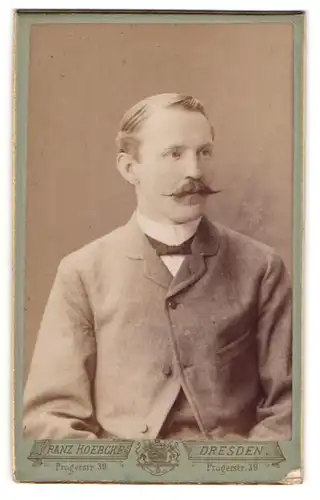 Fotografie Franz Koebcke, Dresden, Portrait junger Herr im Anzug mit Fliege und Zwirbelbart