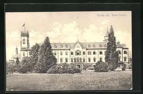 AK Sychrov, Zámek, Blick auf das Schloss hinter den Bäumen