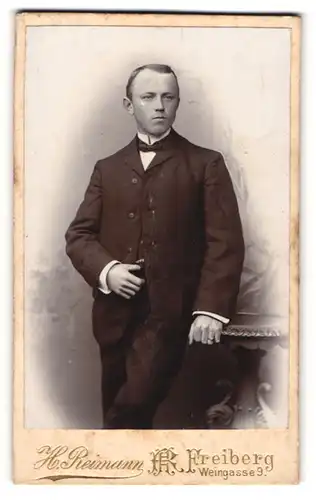 Fotografie H. Reimann, Freiberg, Portrait junger Herr in Anzug mit Fliege