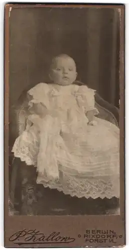 Fotografie P. Zallow, Berlin-Rixdorf, Portrait niedliches Baby im weissen Kleid auf Stuhl sitzend