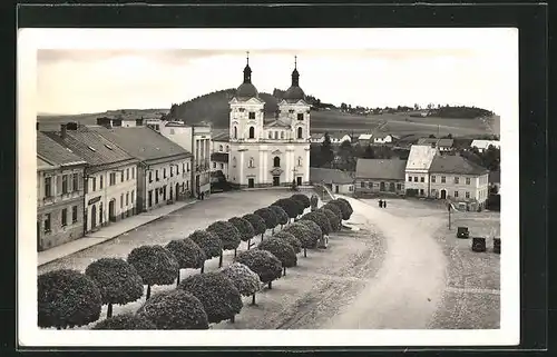 AK Bistritz, Strasse mit Ladengeschäft und Kirche