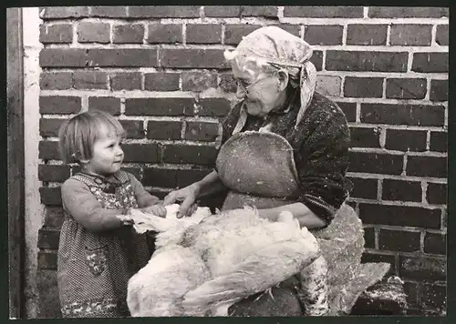 Fotografie Grossmutter beim Gänserupfen und Kind