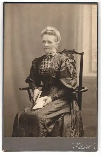 Fotografie Heinr. Sparr, Wandsbek, Schlossstrasse 44, Portrait bürgerliche Dame mit Buch auf Stuhl sitzend