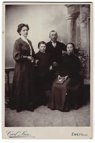 Fotografie Carl Lux, Zwettl, Portrait bürgerliche Familie in hübscher Kleidung mit Buch