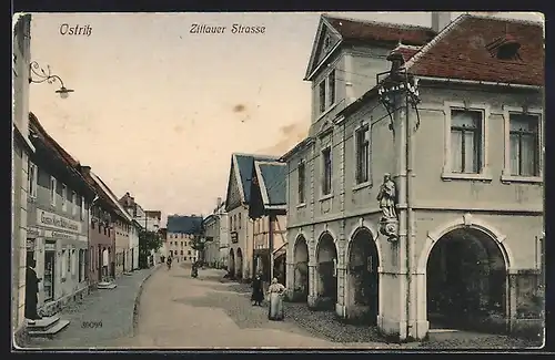 AK Ostritz, Zittauer Strasse mit Geschäften