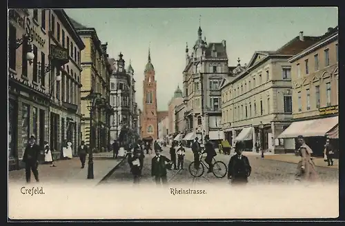 AK Krefeld, Rheinstrasse mit Geschäften und Radfahrer